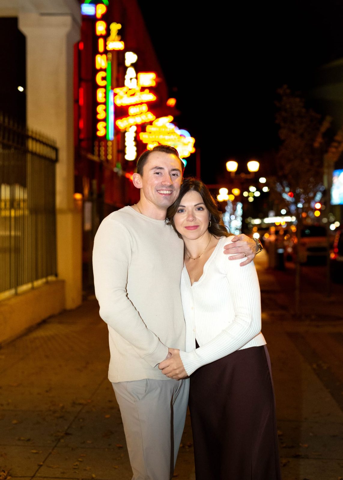 Russell and Wacey standing together on a neon-lit city street at night