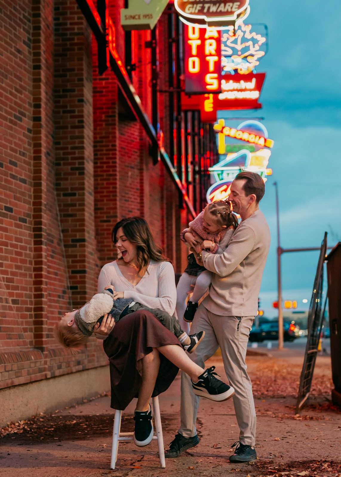 Russell, Wacey, and their kids laughing together on a city street